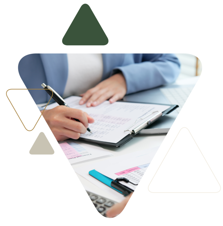 Professional writing on clipboard at office desk