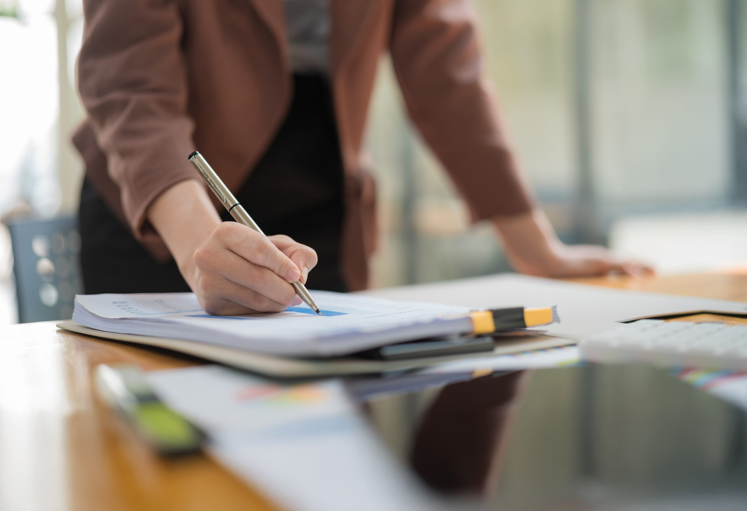 Business owner signing documents at a desk